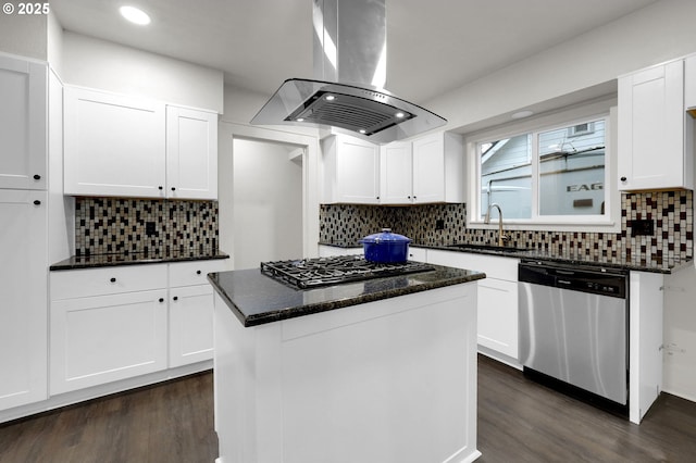 kitchen with island range hood, dark wood-style floors, stainless steel dishwasher, gas stovetop, and a sink