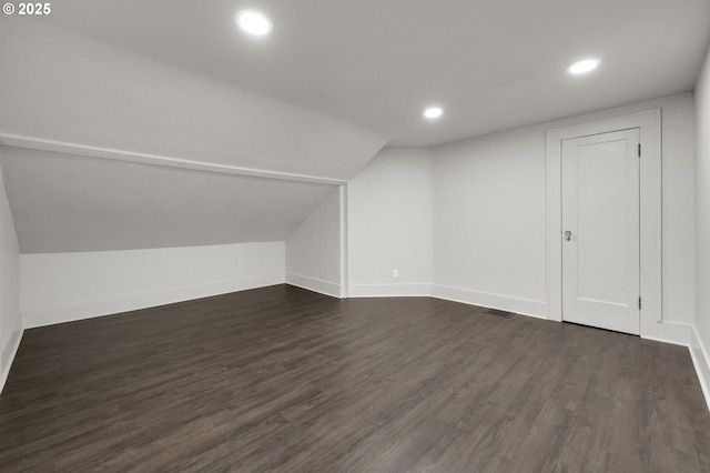 bonus room with baseboards, vaulted ceiling, dark wood-type flooring, and recessed lighting