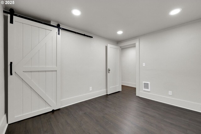 311 N 9th St, Cottage Grove, OR 97424 - basement featuring a barn door, dark wood finished floors, recessed lighting, and baseboards