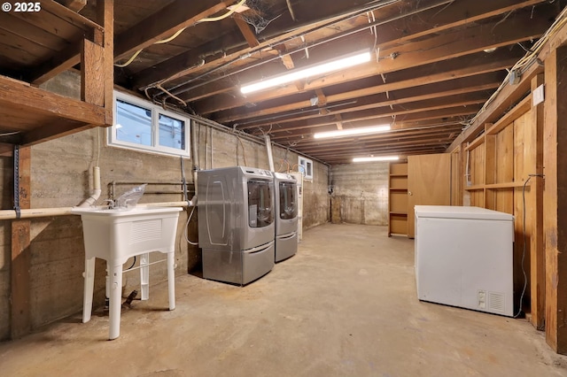 basement featuring washer and clothes dryer and refrigerator