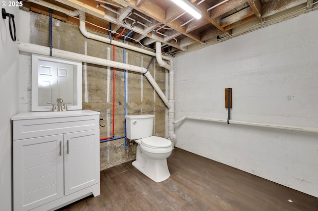 bathroom featuring vanity, toilet, and wood finished floors