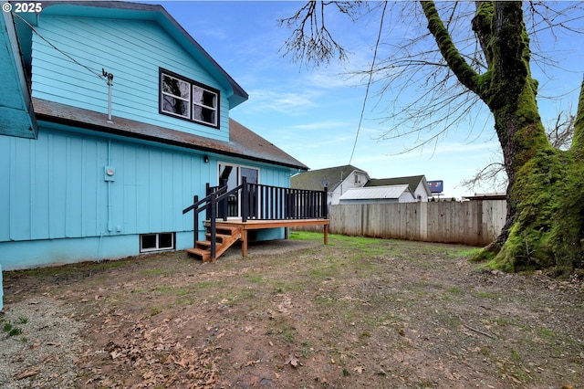 back of property featuring fence and a wooden deck