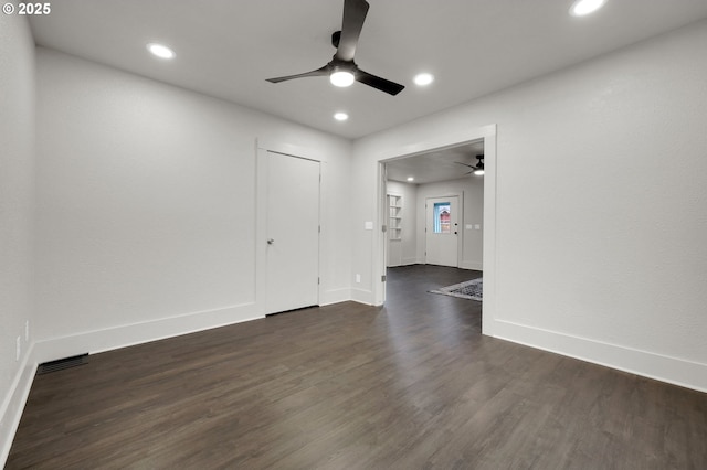 spare room with recessed lighting, dark wood-style flooring, visible vents, and baseboards