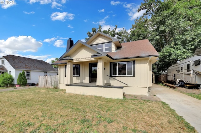 311 N 9th St, Cottage Grove, OR 97424 - rear view of house with a chimney, board and batten siding, and covered porch