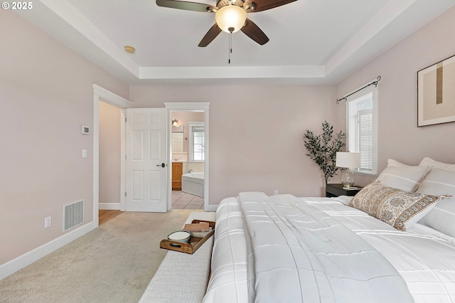 3301 Parker Ln, Springfield, OR 97477 - bedroom featuring a raised ceiling, light colored carpet, connected bathroom, and a ceiling fan