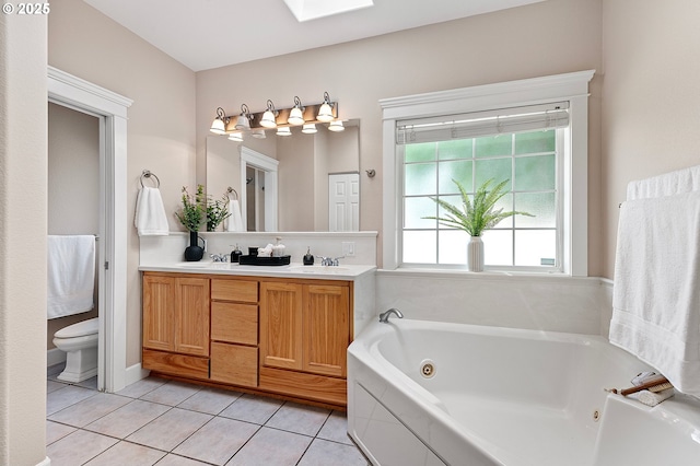 3301 Parker Ln, Springfield, OR 97477 - bathroom featuring a jetted tub, double vanity, tile patterned floors, and a skylight