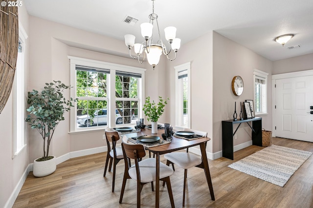 3301 Parker Ln, Springfield, OR 97477 - dining area with a chandelier, wood finished floors, and plenty of natural light