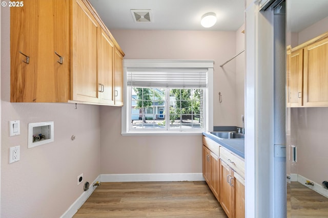 3301 Parker Ln, Springfield, OR 97477 - laundry area with gas dryer hookup, cabinet space, light wood-style flooring, and washer hookup