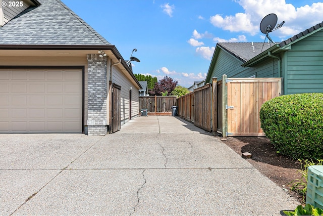 3301 Parker Ln, Springfield, OR 97477 - view of side of property featuring concrete driveway, roof with shingles, and brick siding
