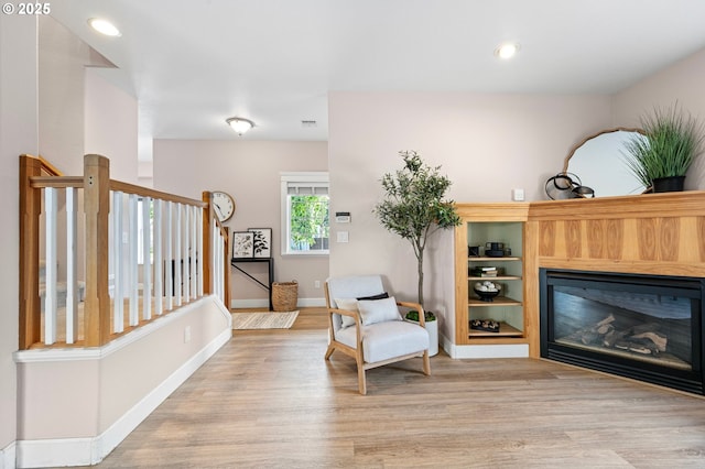 3301 Parker Ln, Springfield, OR 97477 - living area featuring light wood-style floors, a glass covered fireplace, and recessed lighting