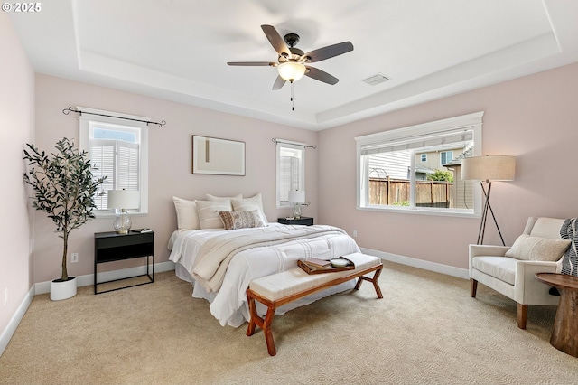 3301 Parker Ln, Springfield, OR 97477 - bedroom featuring a tray ceiling, multiple windows, light carpet, and a ceiling fan