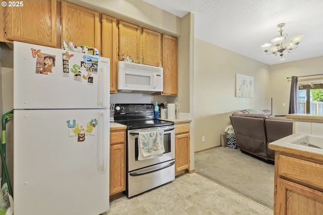 4118/4120 S E St, Springfield, OR 97478 - kitchen with white appliances, open floor plan, light countertops, a chandelier, and light colored carpet