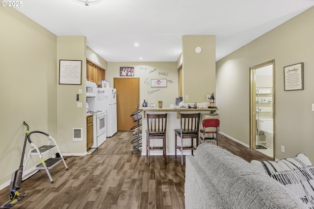 4118/4120 S E St, Springfield, OR 97478 - kitchen with white appliances, dark wood-style floors, a kitchen breakfast bar, recessed lighting, and a peninsula