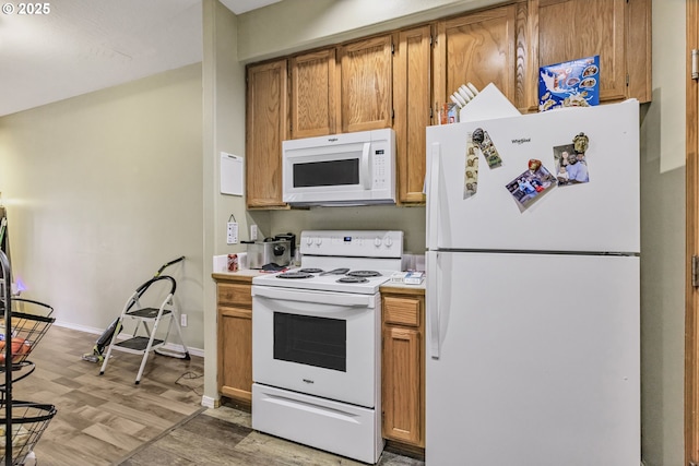 4118/4120 S E St, Springfield, OR 97478 - kitchen with white appliances, light wood-style floors, light countertops, and brown cabinets