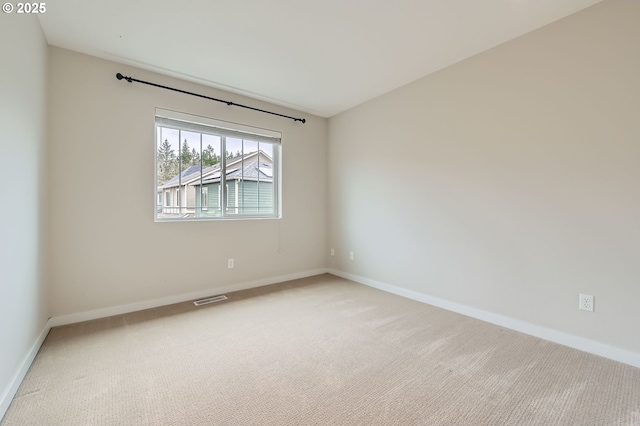 carpeted empty room with baseboards