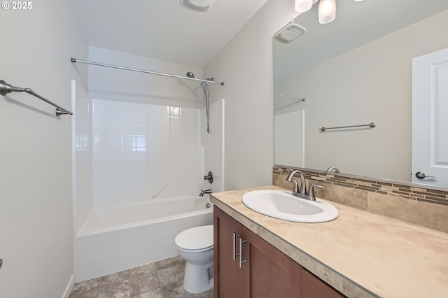 bathroom with toilet, vanity, decorative backsplash, and washtub / shower combination