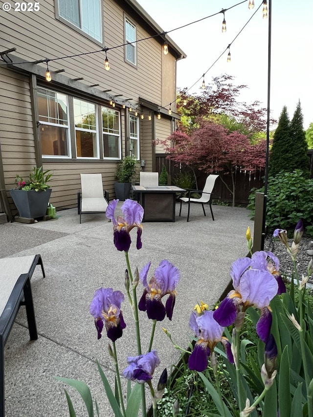view of patio / terrace with fence and an outdoor fire pit
