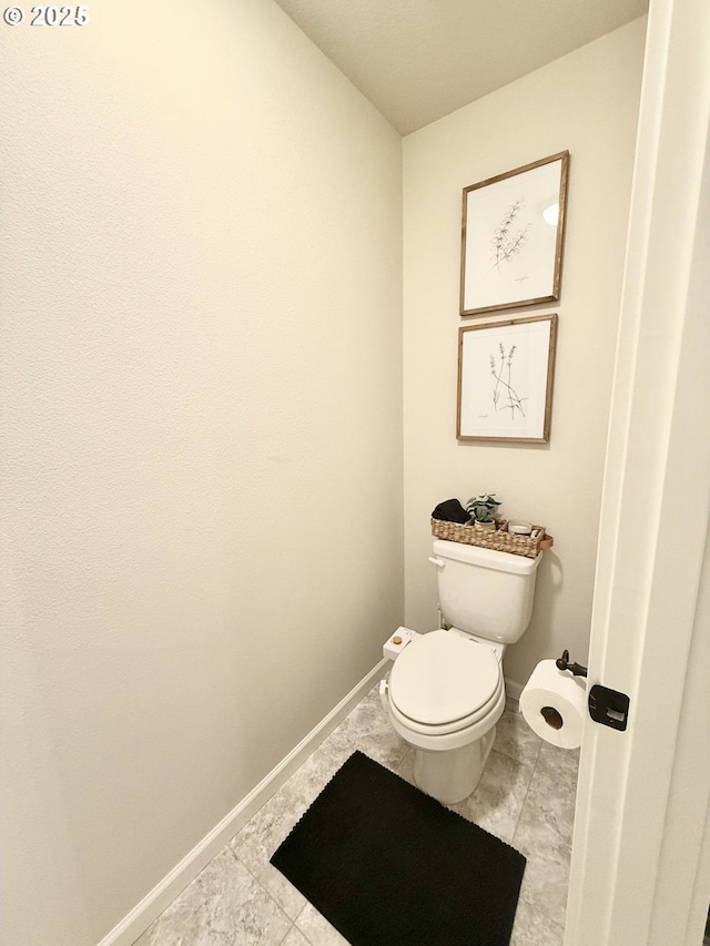 bathroom featuring tile patterned floors and toilet