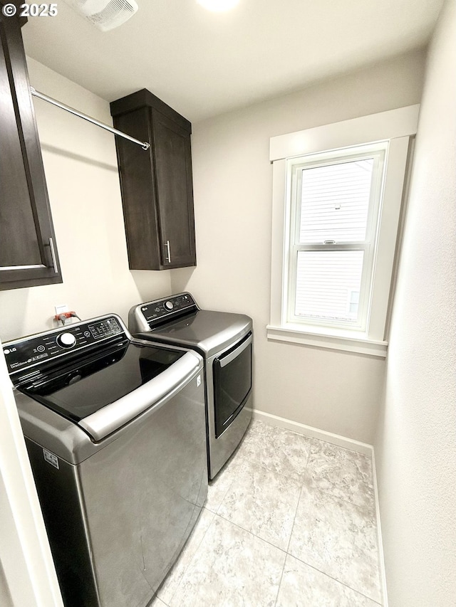 laundry area featuring independent washer and dryer and cabinets