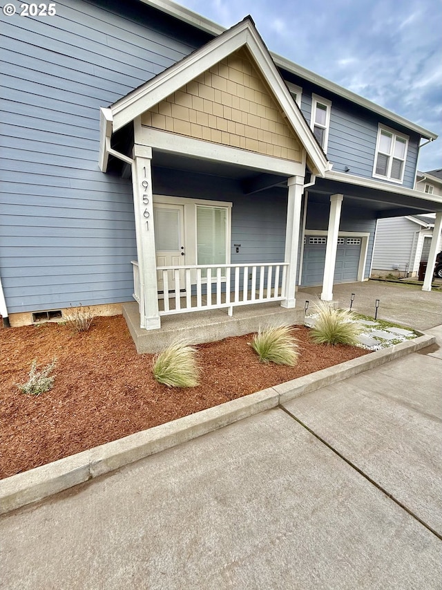 view of front of house with a porch and a garage