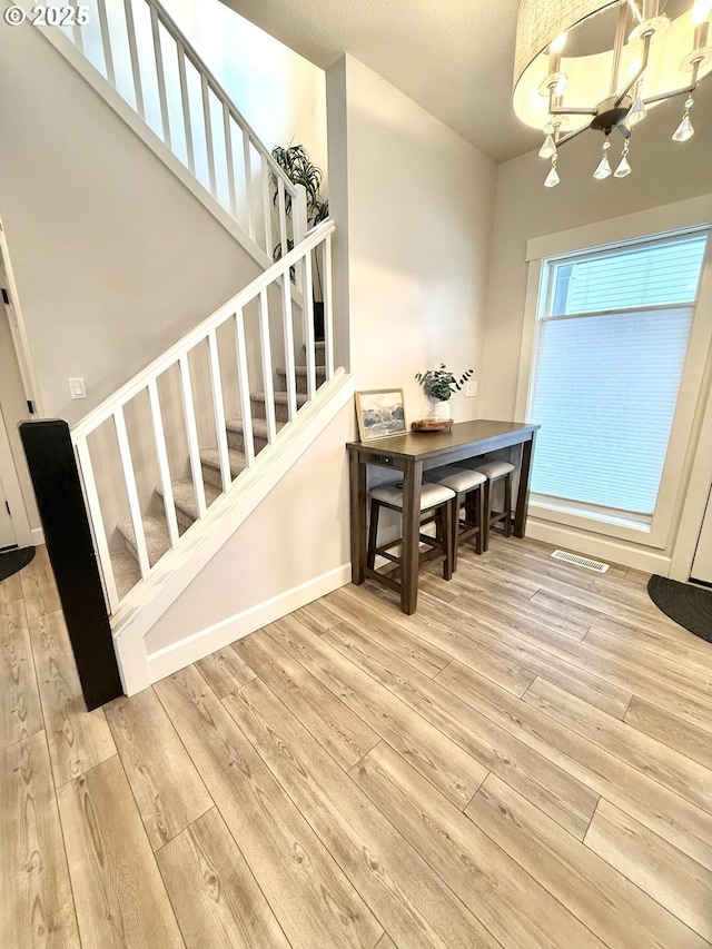 dining room featuring light hardwood / wood-style floors and a notable chandelier