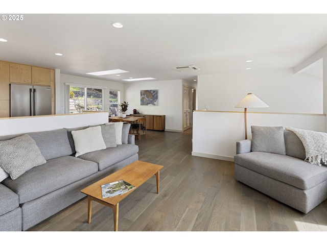 living room featuring light wood-type flooring, recessed lighting, and visible vents