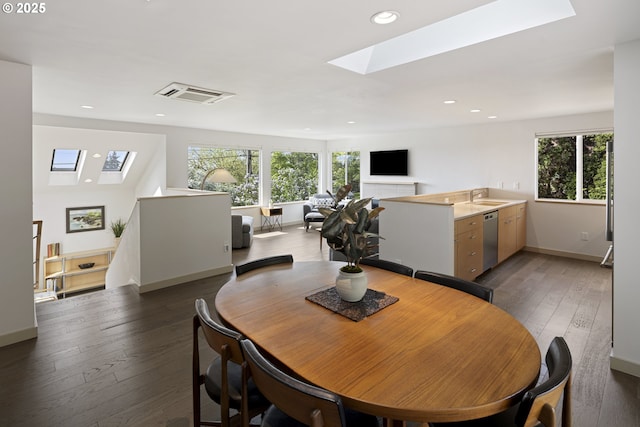 8630 SW 61st Ave, Portland, OR 97219 - dining space with a skylight, plenty of natural light, hardwood / wood-style floors, baseboards, and recessed lighting