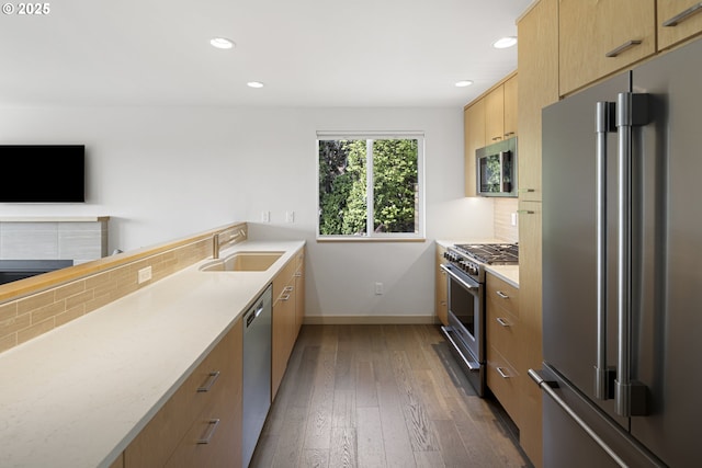 8630 SW 61st Ave, Portland, OR 97219 - kitchen with premium appliances, a sink, decorative backsplash, dark wood-style floors, and recessed lighting