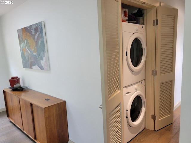8630 SW 61st Ave, Portland, OR 97219 - washroom with stacked washer and clothes dryer and light wood-style floors