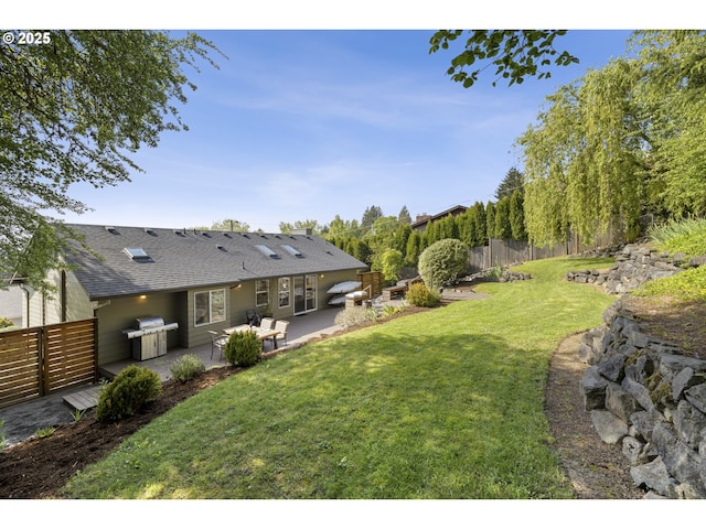 view of yard with fence and a patio area
