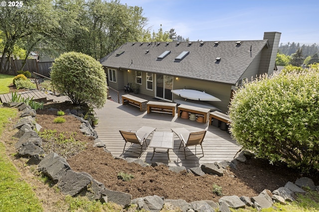 8630 SW 61st Ave, Portland, OR 97219 - back of house featuring a deck, fence, roof with shingles, outdoor dining space, and a chimney