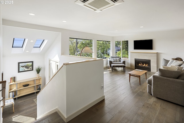 8630 SW 61st Ave, Portland, OR 97219 - living area featuring a fireplace, recessed lighting, dark wood finished floors, baseboards, and a skylight