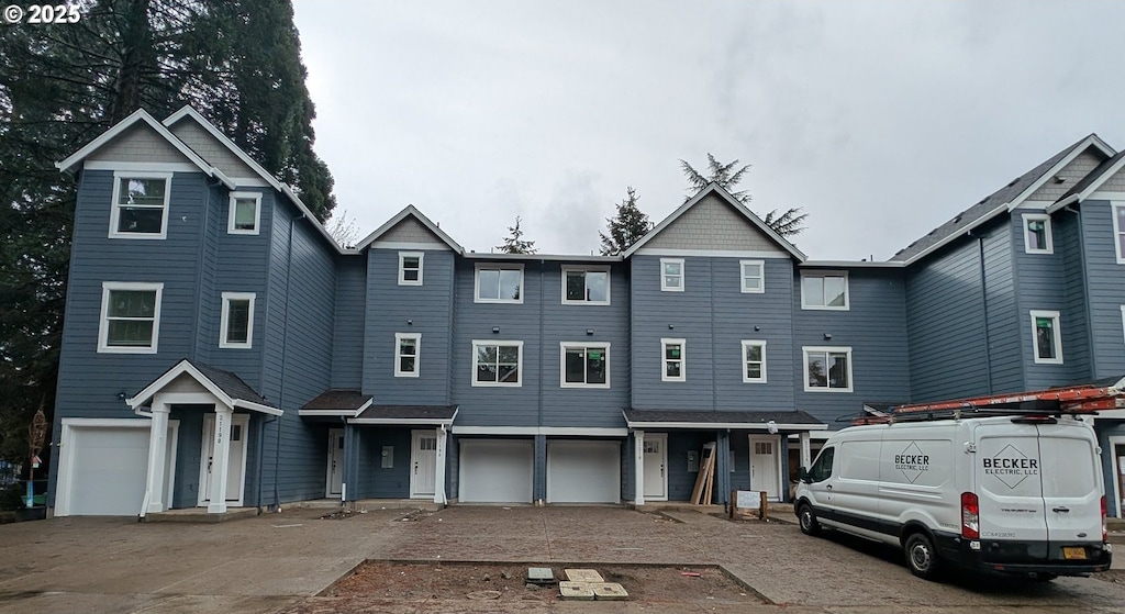 townhome / multi-family property featuring a garage and driveway