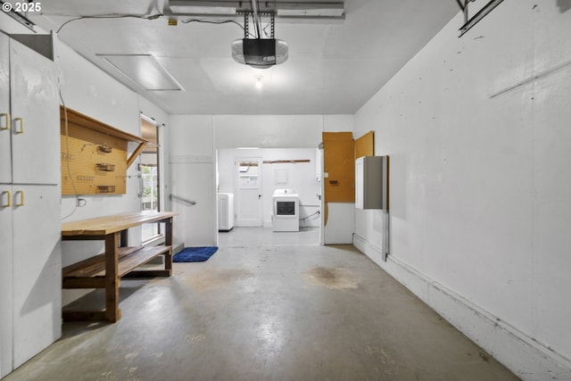 garage with a workshop area, washer / dryer, and a garage door opener