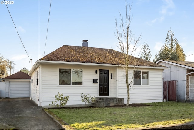 view of front facade featuring a chimney, an outdoor structure, fence, and a front yard