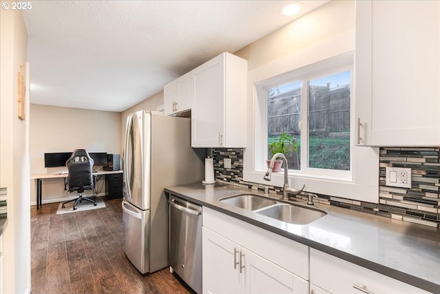6926 SE Deardorff Rd, Portland, OR 97236 - kitchen featuring stainless steel appliances, a sink, tasteful backsplash, white cabinets, and dark wood finished floors