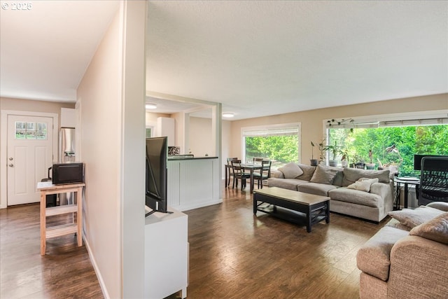 6926 SE Deardorff Rd, Portland, OR 97236 - living area with dark wood-style floors and baseboards