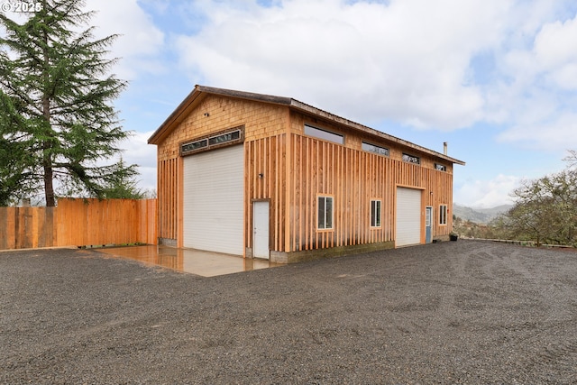 view of outbuilding with an outdoor structure and fence