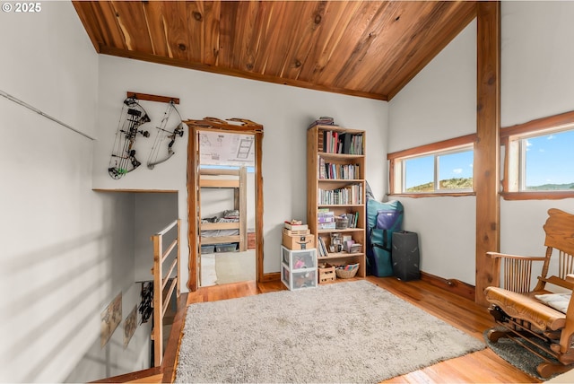 sitting room with wooden ceiling, wood finished floors, lofted ceiling, and ornamental molding