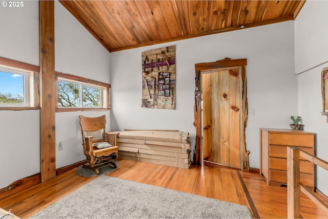 living area featuring wooden ceiling, wood finished floors, lofted ceiling, and ornamental molding