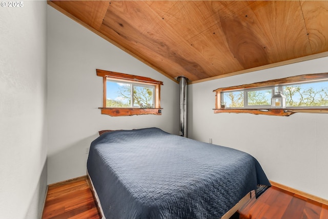 bedroom featuring baseboards, wood finished floors, wooden ceiling, and vaulted ceiling