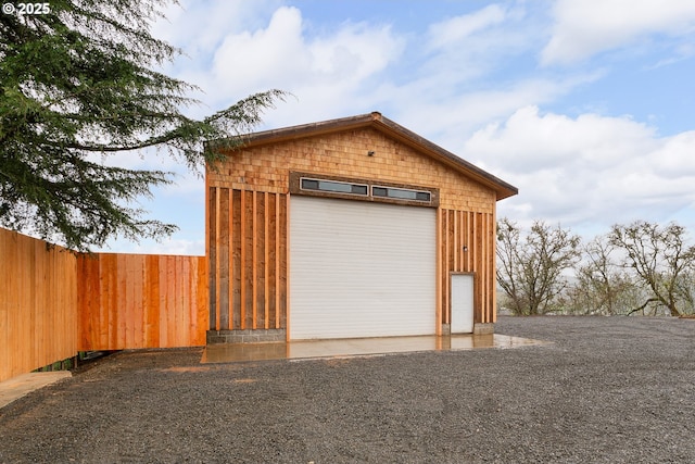 detached garage featuring fence