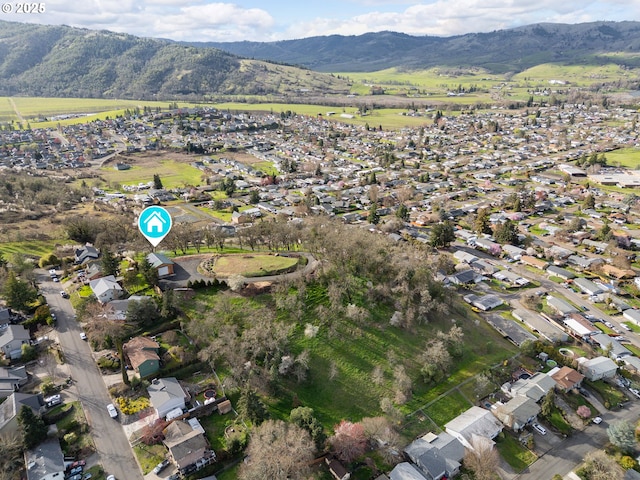 drone / aerial view featuring a residential view and a mountain view