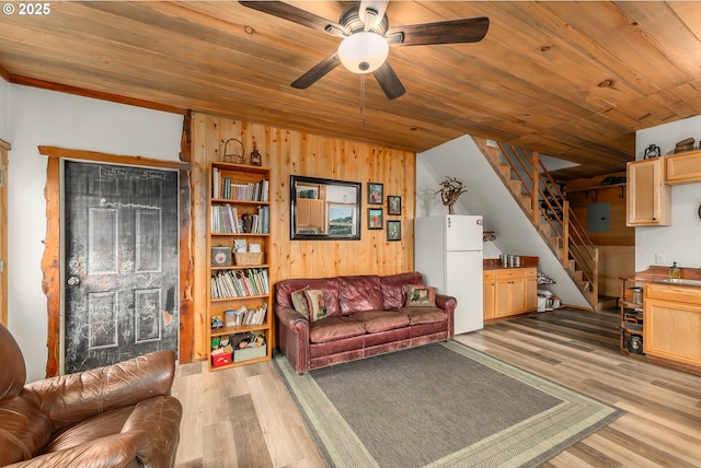 living area featuring light wood finished floors, stairway, and wood ceiling