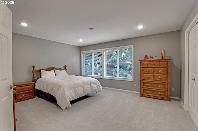 bedroom with light colored carpet, recessed lighting, and baseboards