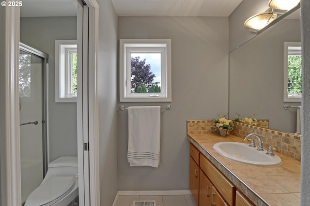 bathroom with plenty of natural light, decorative backsplash, a stall shower, and vanity