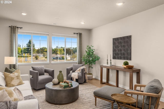 sitting room featuring wood finished floors, recessed lighting, and baseboards