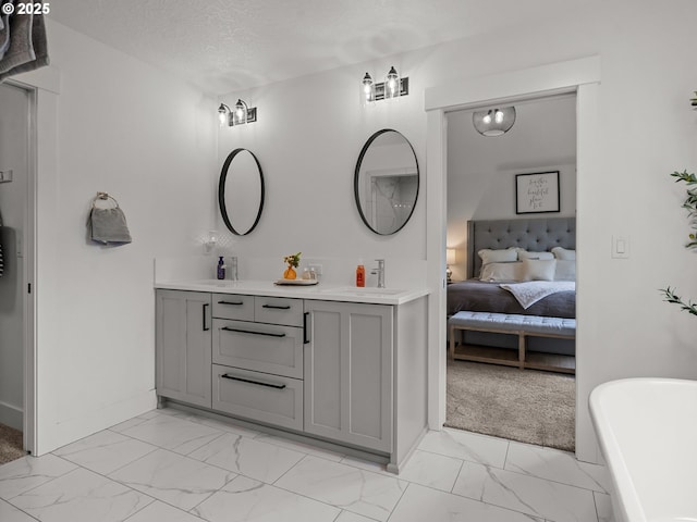 3595 Balm St S, Salem, OR 97302 - ensuite bathroom with marble finish flooring, double vanity, a soaking tub, and a textured ceiling