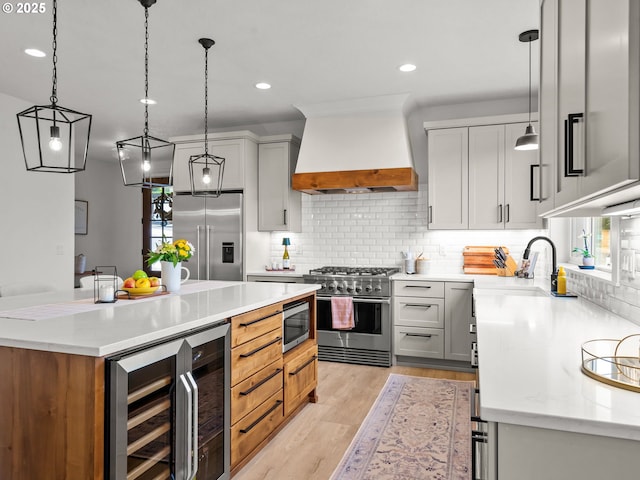 3595 Balm St S, Salem, OR 97302 - kitchen featuring high end appliances, custom exhaust hood, beverage cooler, tasteful backsplash, and light wood-style floors