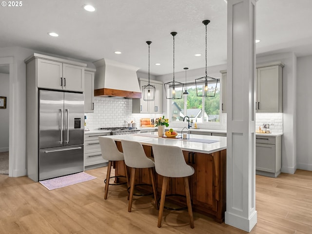 3595 Balm St S, Salem, OR 97302 - kitchen featuring high end fridge, premium range hood, gray cabinets, light countertops, and backsplash